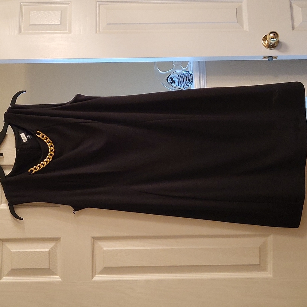 Womens black dress with gold chain.